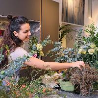 lady picking flowers in shop