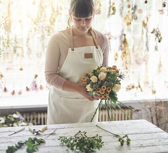 Lady in shop arranging flowers